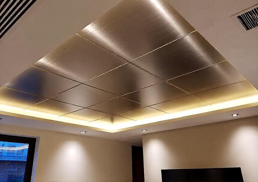 Close-up interior scene of a luxury home with 3mm anodized and brushed aluminium ceiling panels, emphasizing texture, lighting, and elegance in high-end interior decoration.