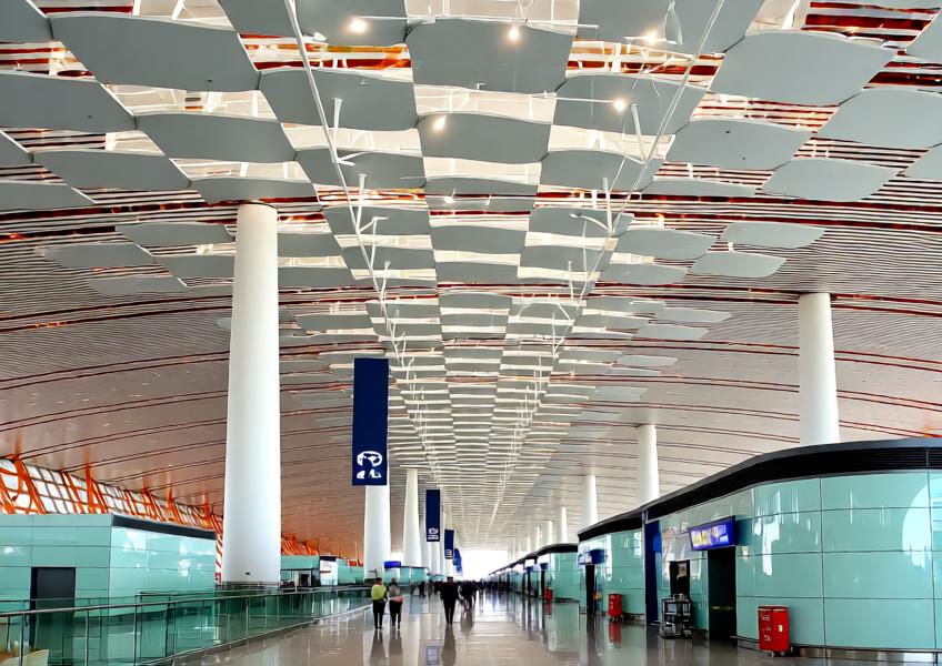 Interior view of an airport terminal featuring functional decorative ceiling panels that combine aesthetics, acoustics, and sustainability.